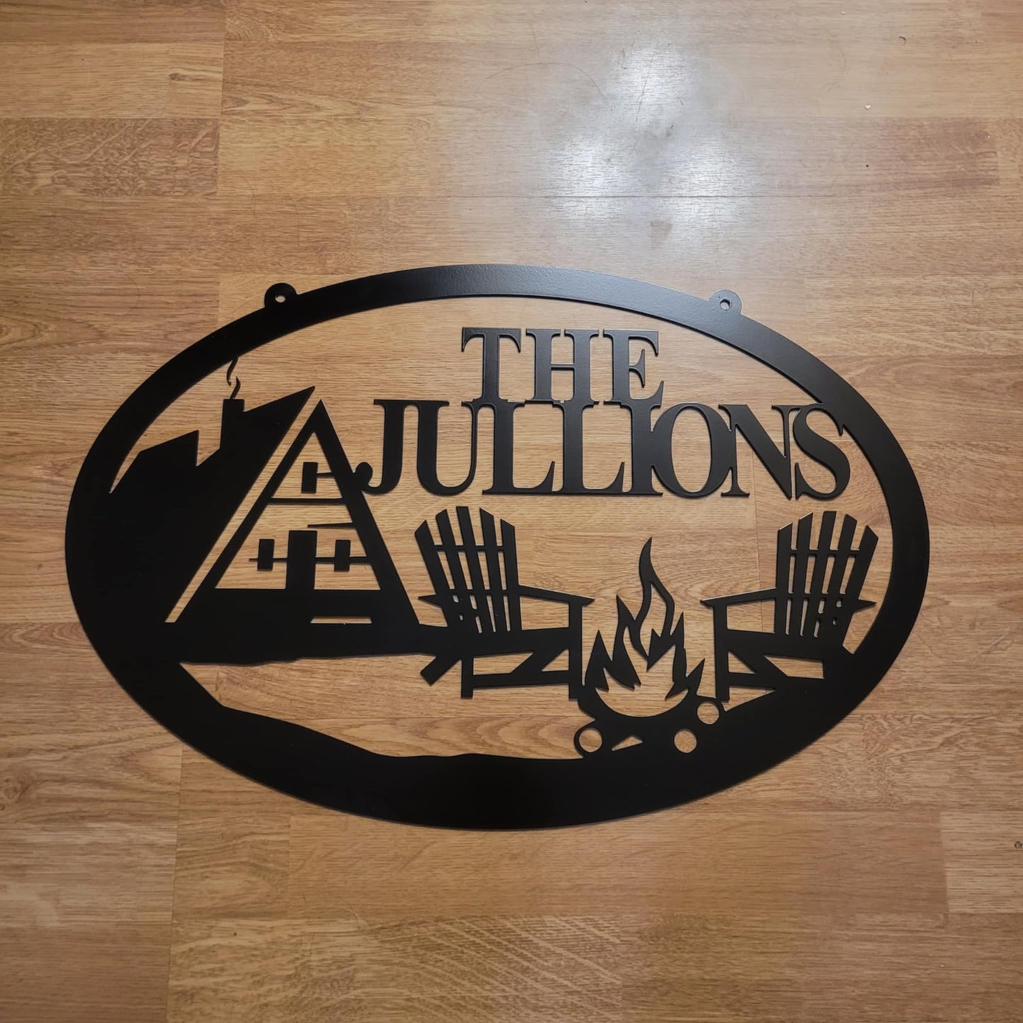 Rustic Oval Metal Sign with A-Frame Cabin and Campfire